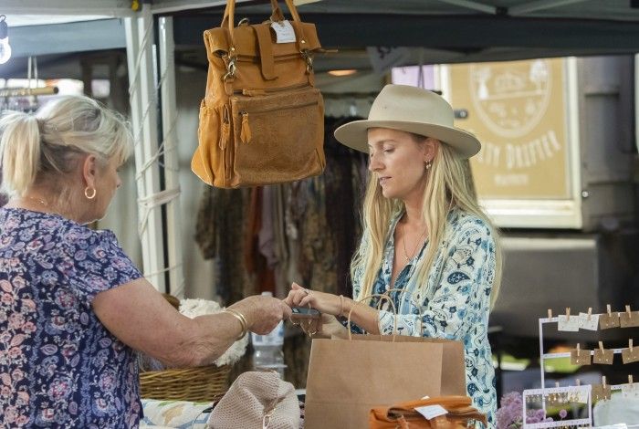 Image of stallholder assisting customer 